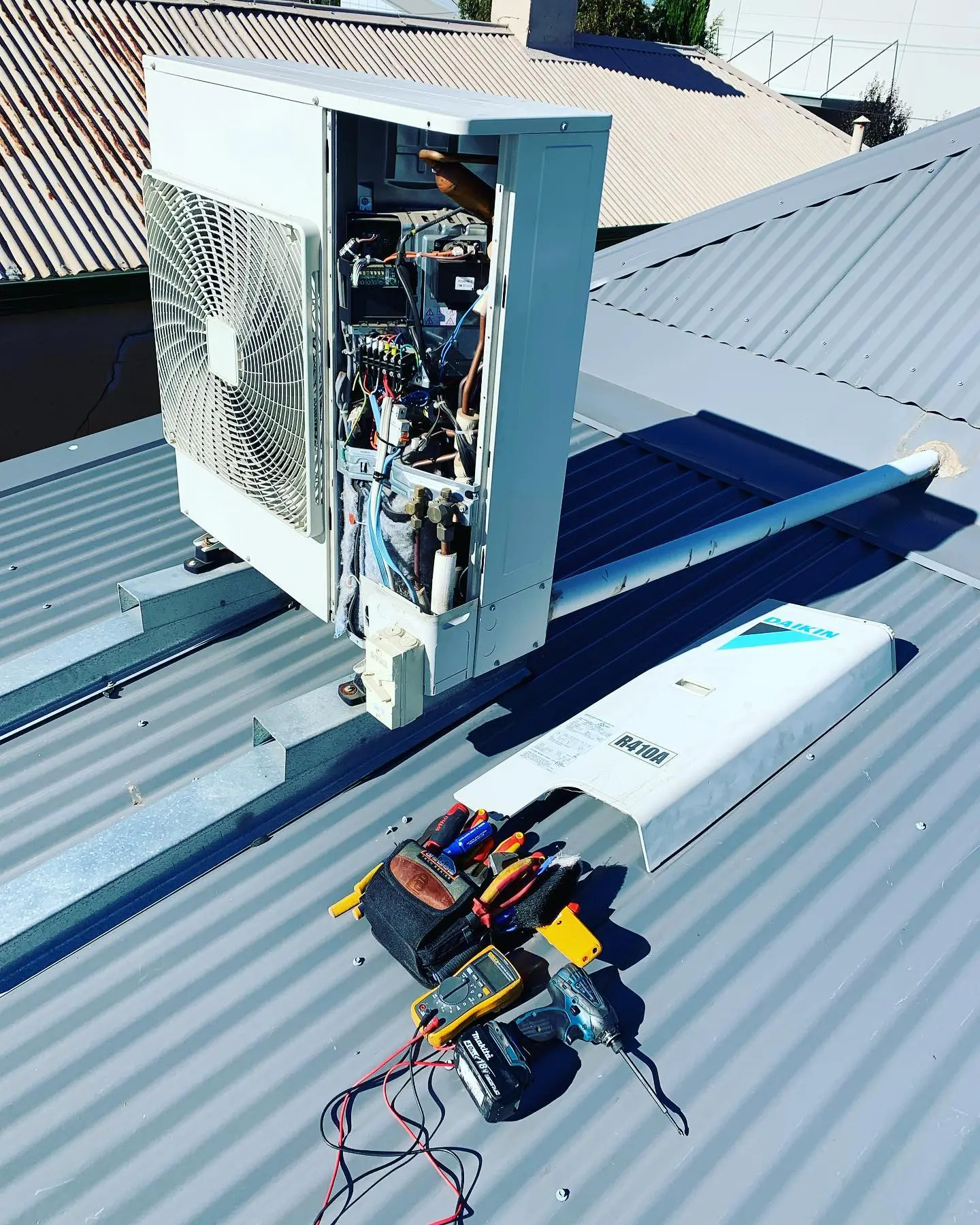 Repairing a airconditioner on a roof in Adelaide.