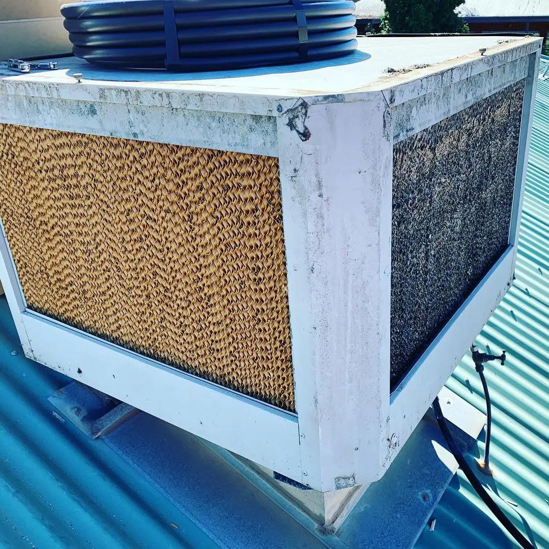 An old and dirty Brivis Evaporative Air Conditioner on the roof of a house before we serviced.