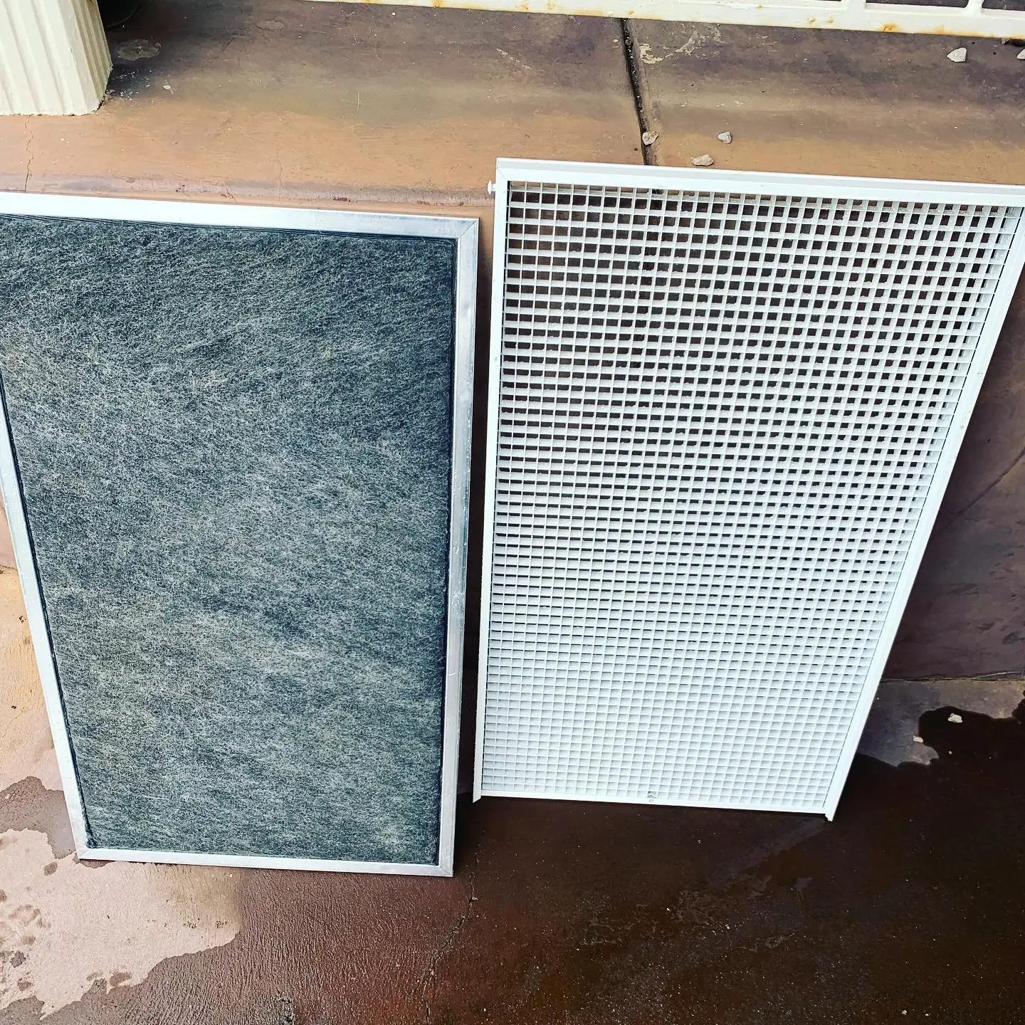 Air conditioner filters leaning on a wall.